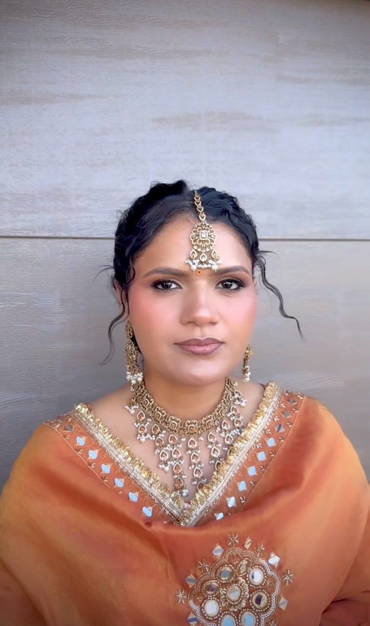 Occasion makeup and an updo with traditional jewellery and an orange outfit